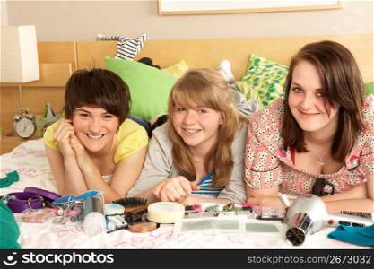 Group Of Teenage Girls In Untidy Bedroom