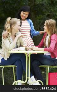 Group Of Teenage Girls Sitting At Outdoor cafe