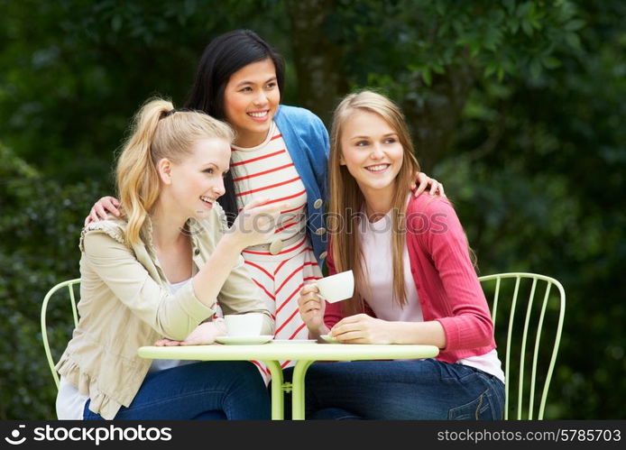 Group Of Teenage Girls Sitting At Outdoor cafe