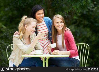 Group Of Teenage Girls Sitting At Outdoor cafe