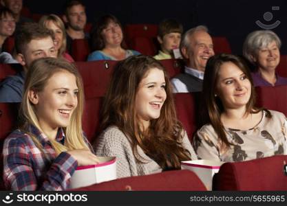 Group Of Teenage Girls Watching Film In Cinema