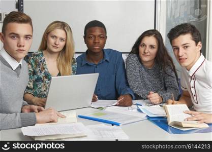 Group Of Teenage Pupils Working In Classroom