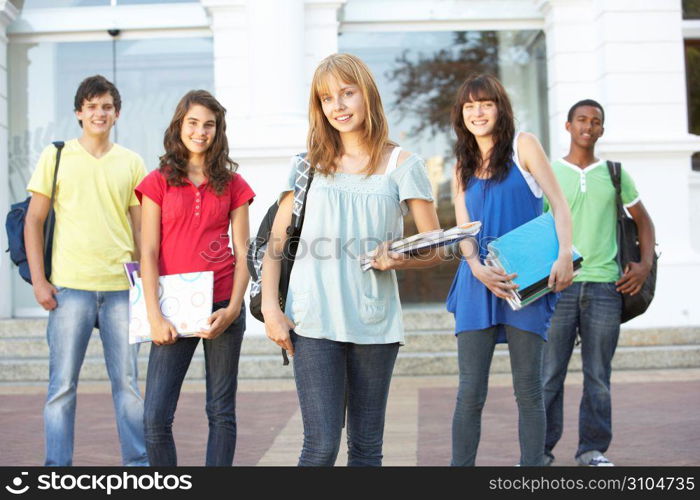 Group Of Teenage Students Standing Outside College Building