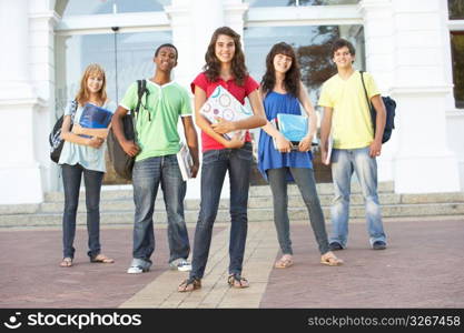 Group Of Teenage Students Standing Outside College Building