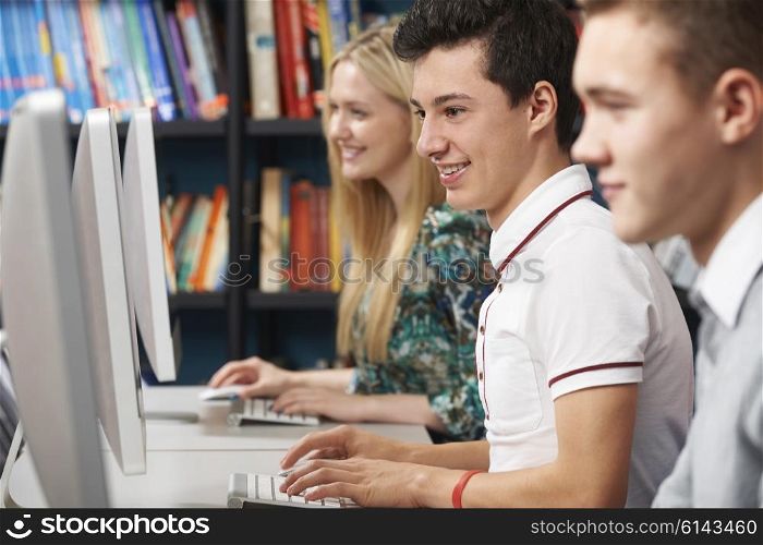Group Of Teenage Students Working At Computers In Classroom