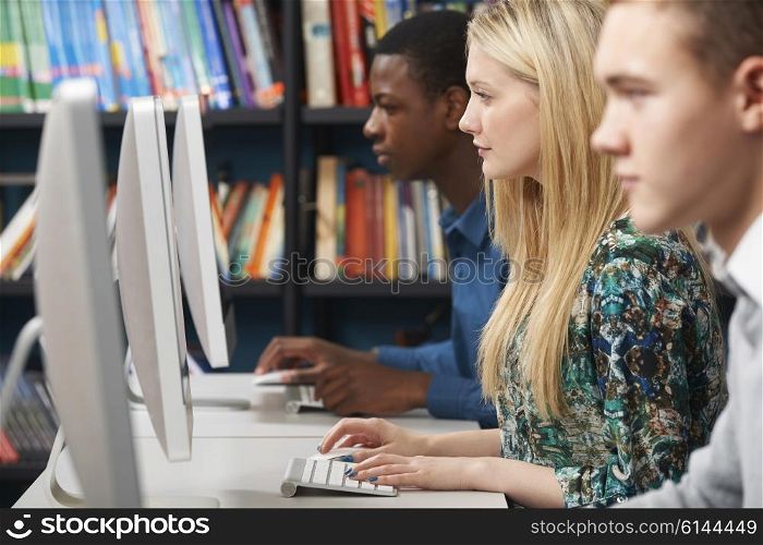 Group Of Teenage Students Working At Computers In Classroom