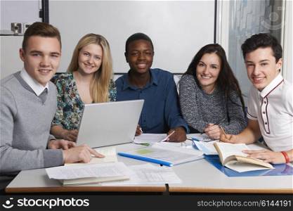 Group Of Teenage Students Working In Classroom