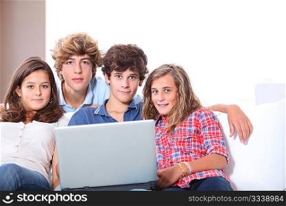 Group of teenagers at home with laptop