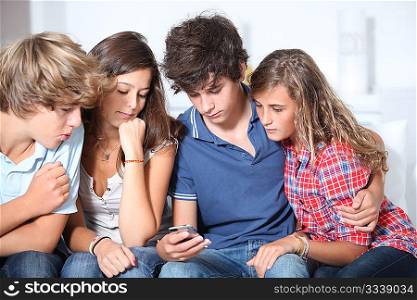 Group of teenagers at home with music player