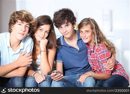 Group of teenagers at home with music player