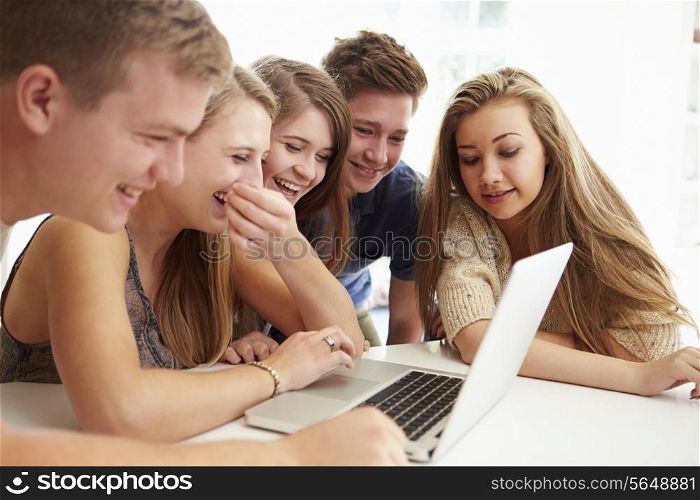 Group Of Teenagers Gathered Around Laptop Together