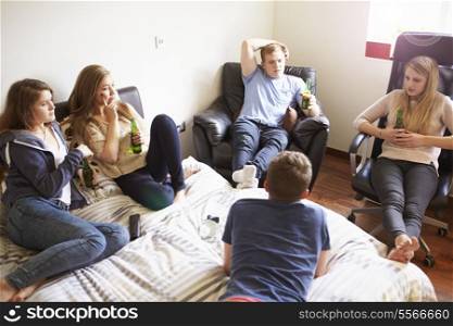 Group Of Teenagers Relaxing In Bedroom