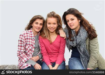 Group of teenagers sitting on school bench