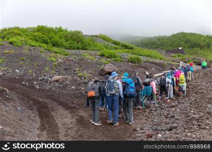 Group of the hikers on the trail in the Fuji mountains.