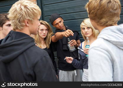 Group Of Threatening Teenagers Hanging Out Together Outside Drinking