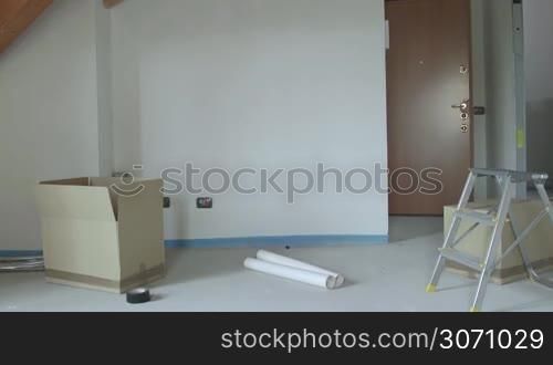 Group of three happy friends during move to new home, young people and rent, students moving to new rental apartment with boxes, portrait of man and women hugging, smiling to camera. 7 of 15