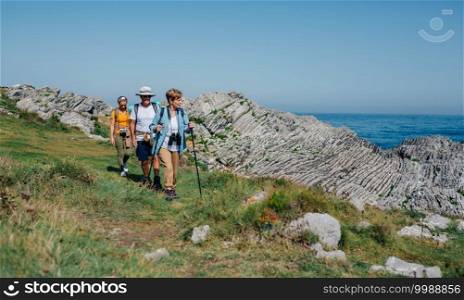 Group of three people practicing trekking outdoors. Three people practicing trekking outdoors