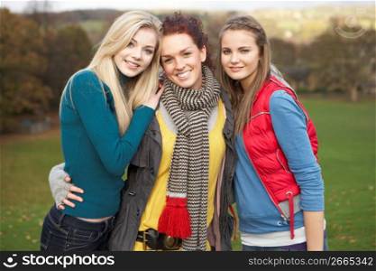 Group Of Three Teenage Female Friends In Autumn Landscape