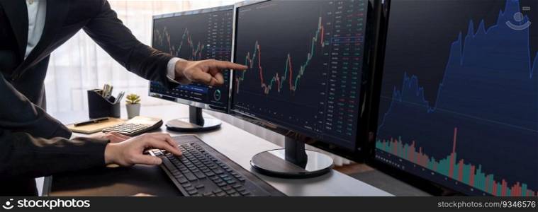 Group of traders discussing on office desk, monitoring stock market on monitor at office workplace. Businessman and broker analyzing stock graph together at stock trading company. Trailblazing. Businessman and broker analyzing stock graph at trading company. Trailblazing