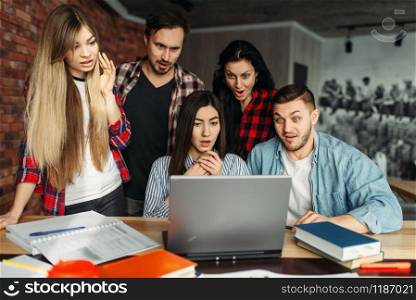 Group of university students prepares for exams together. People with laptop search information in internet. Group of university students prepares for exams