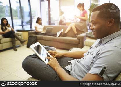 Group Of University Students Relaxing In Common Room
