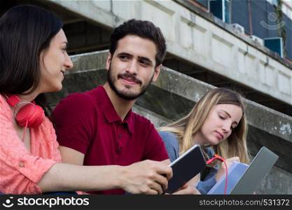 Group of University students studying together at the building of university. Education concept