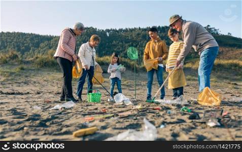 Group of volunteers preparing to clean the beach. Volunteers preparing to clean the beach