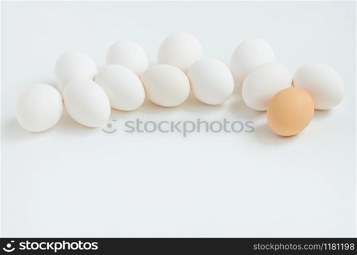 Group of white eggs on white background. Getting ready for the Easter holiday. One leader among all.. Group of white eggs on white background. Getting ready for the Easter holiday.