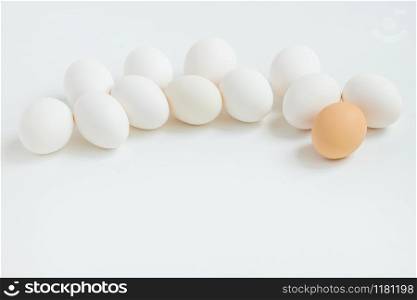 Group of white eggs on white background. Getting ready for the Easter holiday. One leader among all.. Group of white eggs on white background. Getting ready for the Easter holiday.