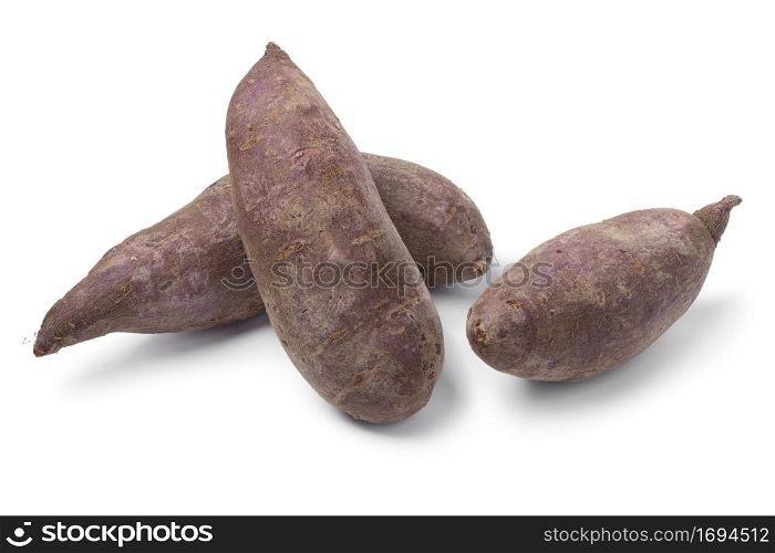 Group of whole fresh purple sweet potatoes isolated on white background