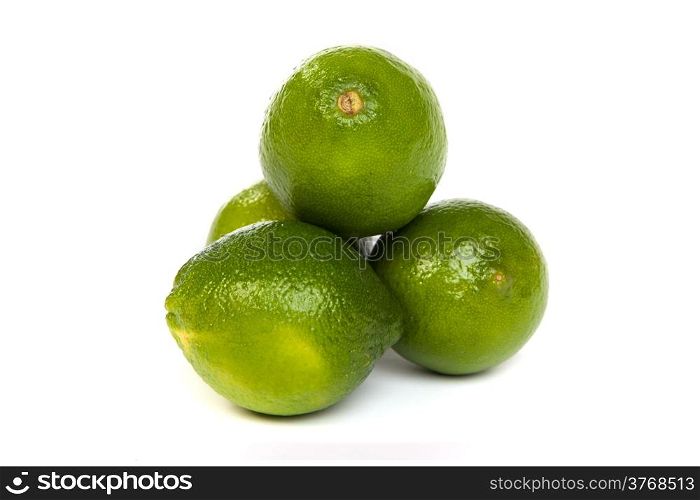 Group of whole limes and one half lime isolated on a white background