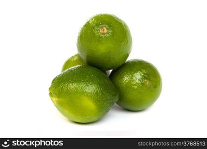 Group of whole limes and one half lime isolated on a white background