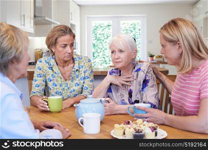 Group Of Women Consoling Unhappy Friend At Home