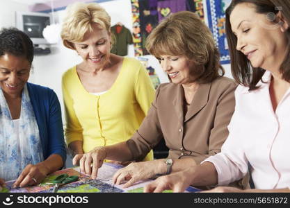 Group Of Women Making Quilt Together