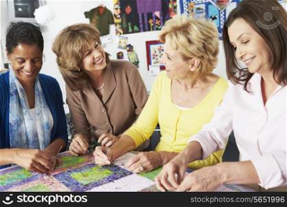 Group Of Women Making Quilt Together