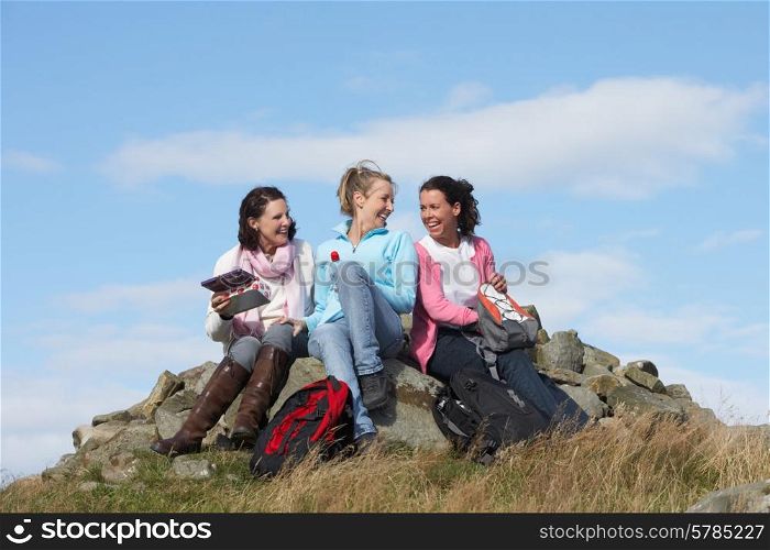 Group Of Women Stopping For Lunch On Countryside Walk