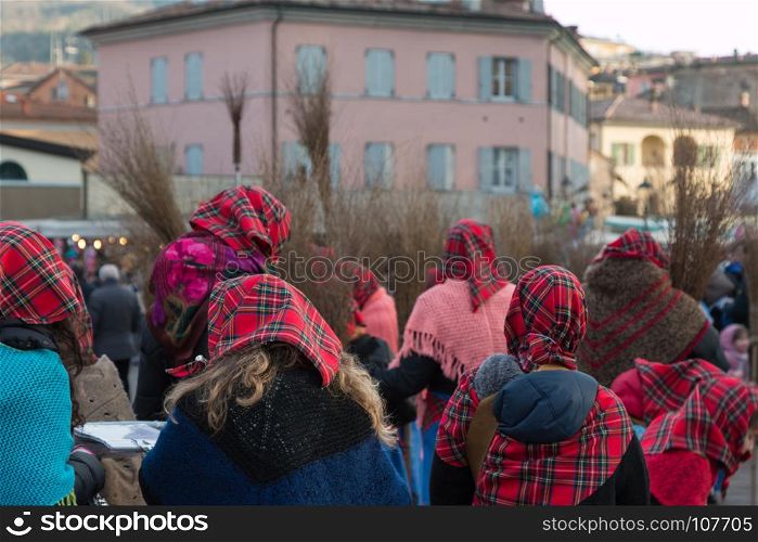 Group of Women with Red Scottish Kerchief and Shawles in Public Ground. Group of Women with Red Scottish Kerchief and Shawles in Public