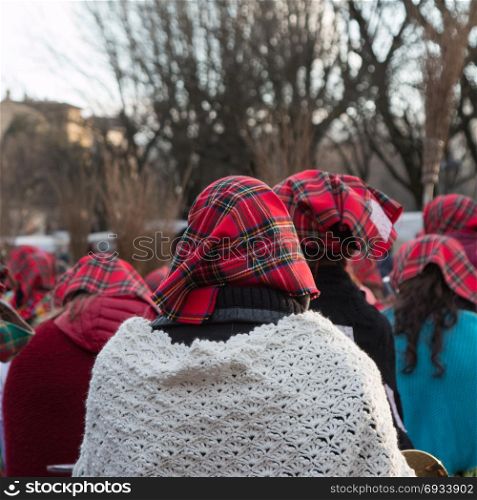 Group of Women with Red Scottish Kerchief and Shawles in Public Ground