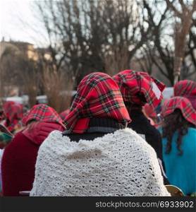 Group of Women with Red Scottish Kerchief and Shawles in Public Ground
