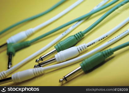 Group of yellow and green cables with audio plugs, close-up