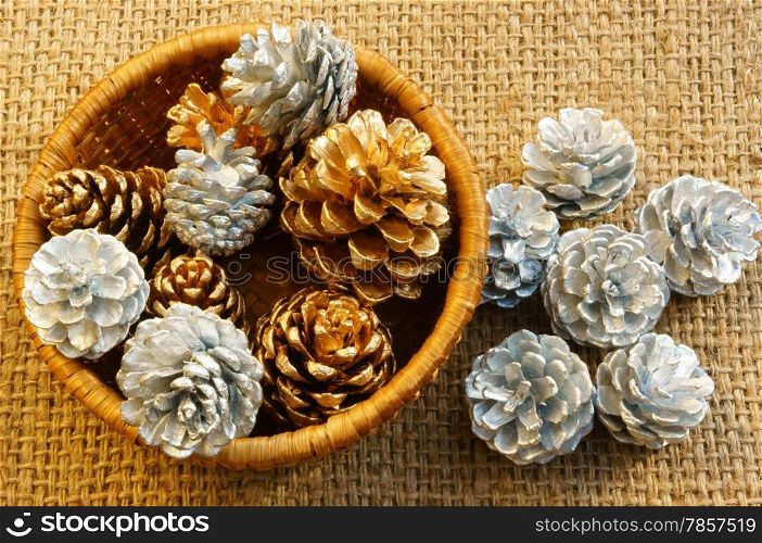 Group of yellow and white pine cone in art basket, this cone to decorate for Xmas season, in brown color make abstract symbol for Christmas eve