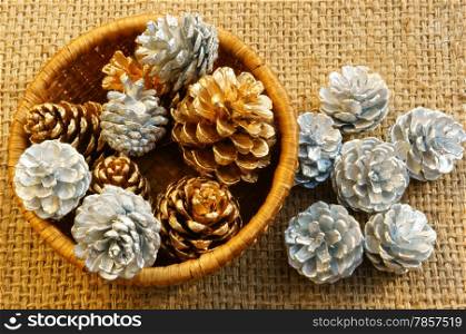 Group of yellow and white pine cone in art basket, this cone to decorate for Xmas season, in brown color make abstract symbol for Christmas eve