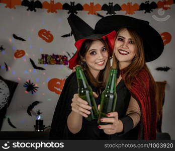 Group of young adult and teenager people celebrating a Halloween party carnival Festival in Halloween costumes drinking alcohol beer