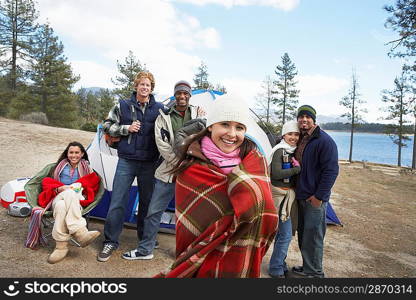 Group of young adults outdoors at campsite front view.