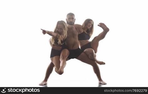 group of young athletic dance partners in black tights performing modern style ballet making acrobatic elements  group of sporty ballet dancers in art performance in front of white background