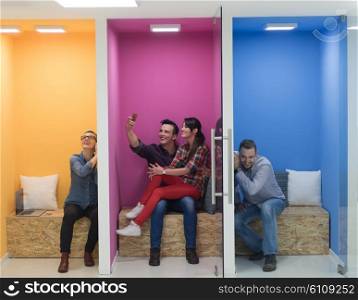 group of young business people having fun, relaxing and working in creative room space at modern startup office