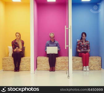 group of young business people having fun, relaxing and working in creative room space at modern startup office