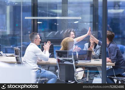 Group of young business people looking happy while celebrating success at their working places in startup office