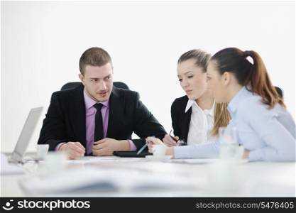 Group of young business people sitting in board room during meeting and discussing with paperwork