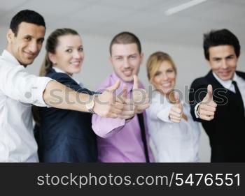 Group of young business people sitting in board room during meeting and discussing with paperwork